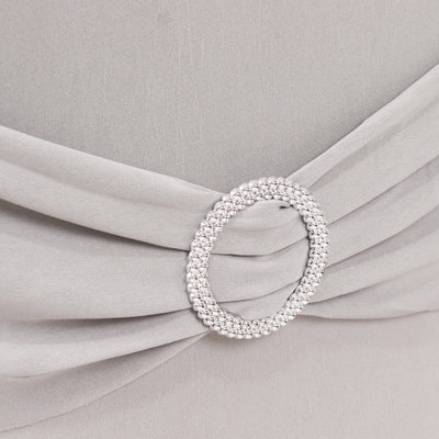 Silver embellished belt detail on gray fabric dress.