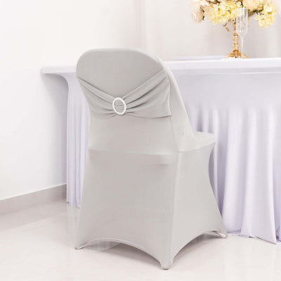 Gray chair cover with decorative bow and ring detail on a plain white backdrop.