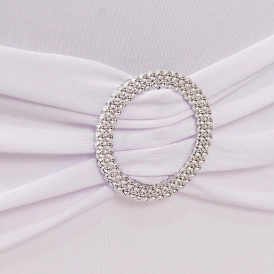 White dress with jeweled circular embellishment detail.