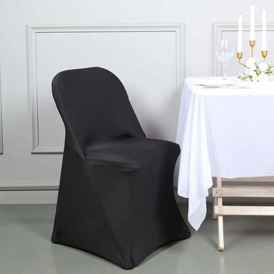 Black chair cover on a banquet chair beside a dining table.