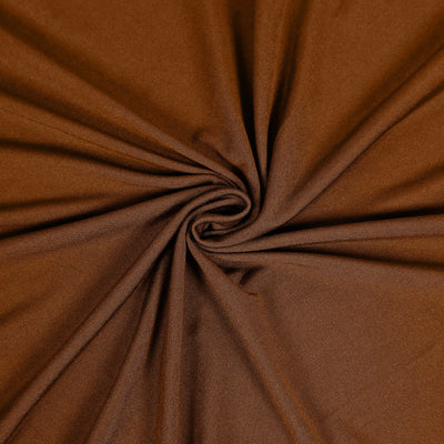Brown fabric texture in a swirl pattern.