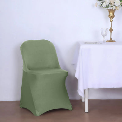Green chair cover draped over a chair beside a table with a white tablecloth.