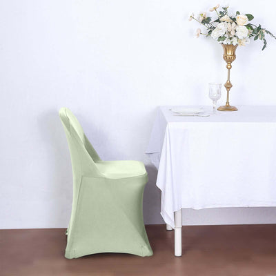 Green chair cover displayed beside a dining table with floral decor.