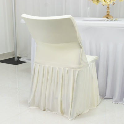 White chair with pleated skirt against a plain backdrop.