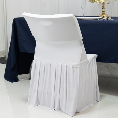 White folding chair with skirt at a dining table setting.