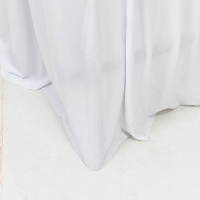White tablecloth draping elegantly on a smooth surface.