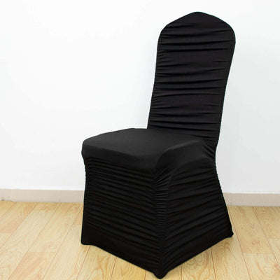 Black chair cover with ruched design, perfect for enhancing event decor.