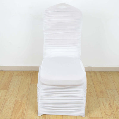 White stretch chair cover on a plain backdrop