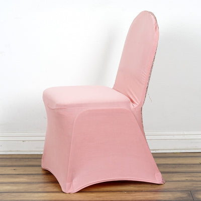 Pink chair cover with decorative trim, side view.