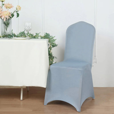 Blue chair cover draped over a chair beside a table with flowers.