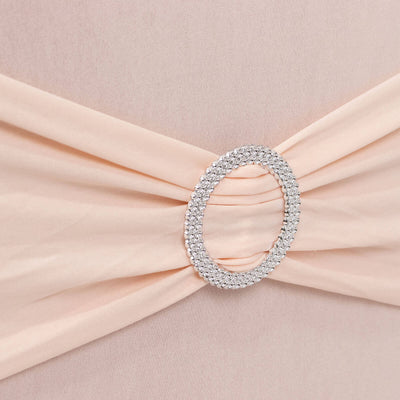 Elegant peach dress with a jeweled belt detail.