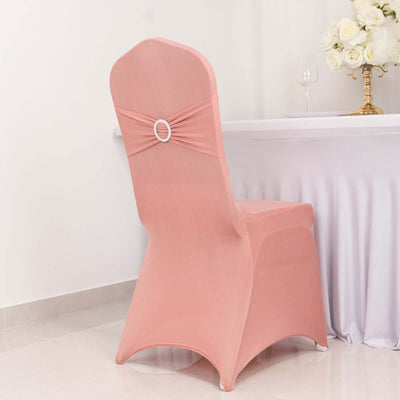 Peach-colored chair cover with decorative bow and ring detail.