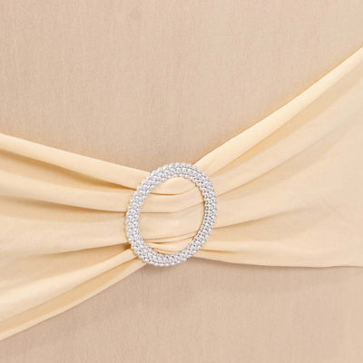 Elegant beige dress with a sparkling crystal belt detail.