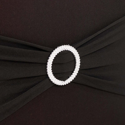 Black dress with a pearl-embellished belt detail.