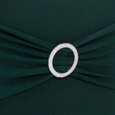 Emerald green dress with a decorative silver brooch detail.