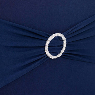 Navy dress detail with embellished waist, showcasing elegant design.