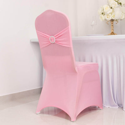 Pink chair cover with decorative bow and ring detail.