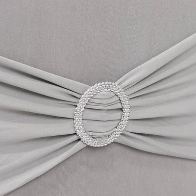 Elegant gray fabric with a sparkling jeweled brooch detail.