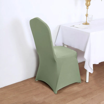 Green chair cover draped over a chair beside a table.