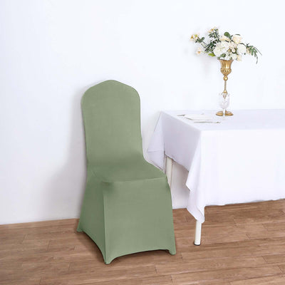 Green chair cover on a chair beside a table with flowers