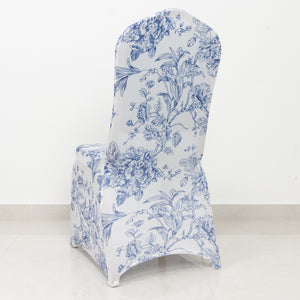 Floral print chair slipcover in blue and white on a plain backdrop.