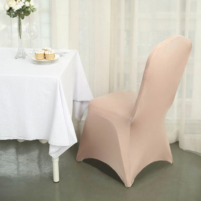 Elegant beige chair cover on a dining chair beside a table with cupcakes.