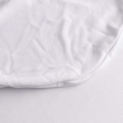 Close-up of soft white fabric texture with folded edge.
