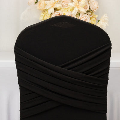Black chair cover with elegant draping design.