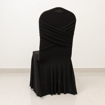 Black chair cover with draped fabric design, shown from the back.