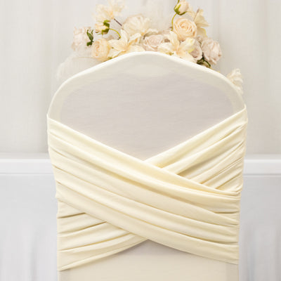Elegant cream chair cover with floral arrangement on top.