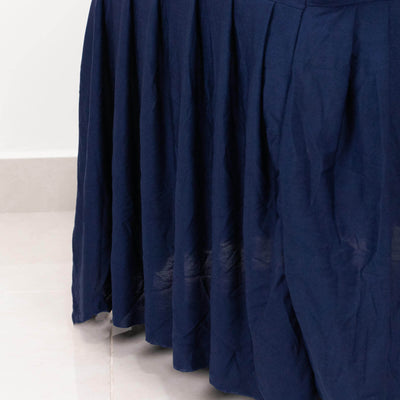 Navy blue skirt with flowing fabric and subtle texture.