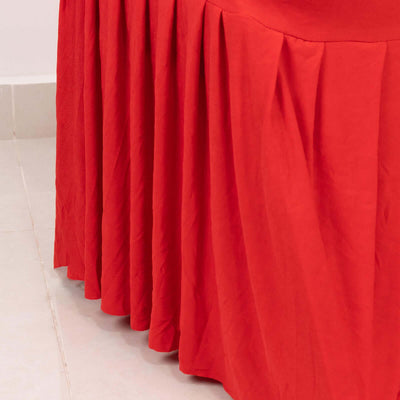 Red table skirt with pleats, perfect for events and decorations.