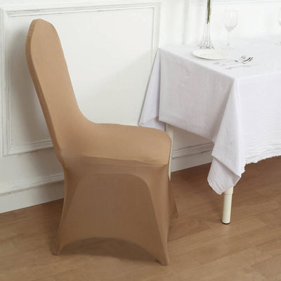 Tan chair cover on a dining chair beside a table with a white tablecloth.