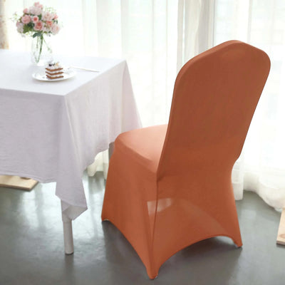 Orange chair near a table with a dessert, set in a bright, airy room.