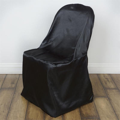 Black satin chair cover on a wooden floor.