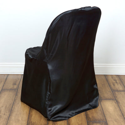 Black chair cover on a wooden floor backdrop.