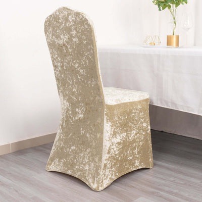 Elegant gold velvet dining chair with a curved back and sleek design.