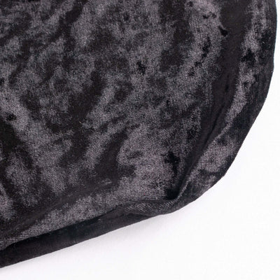 Black velvet fabric texture close-up showing soft sheen and rich color.