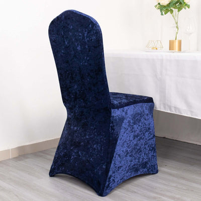 Navy blue velvet chair cover for elegant dining setups.