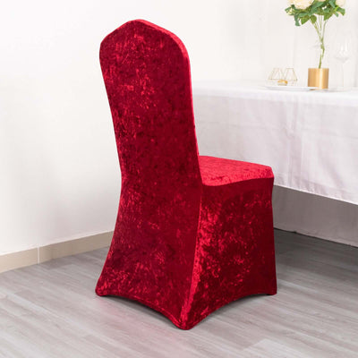 Red velvet chair cover on a plain backdrop.