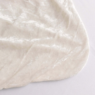 Soft beige velvet fabric with a smooth texture.