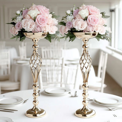 Elegant floral centerpieces in gold vases for wedding decor.