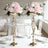 Elegant floral centerpieces in gold vases for wedding decor.