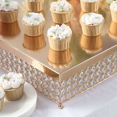 Elegant cupcake display on a mirrored stand with decorative crystal accents.