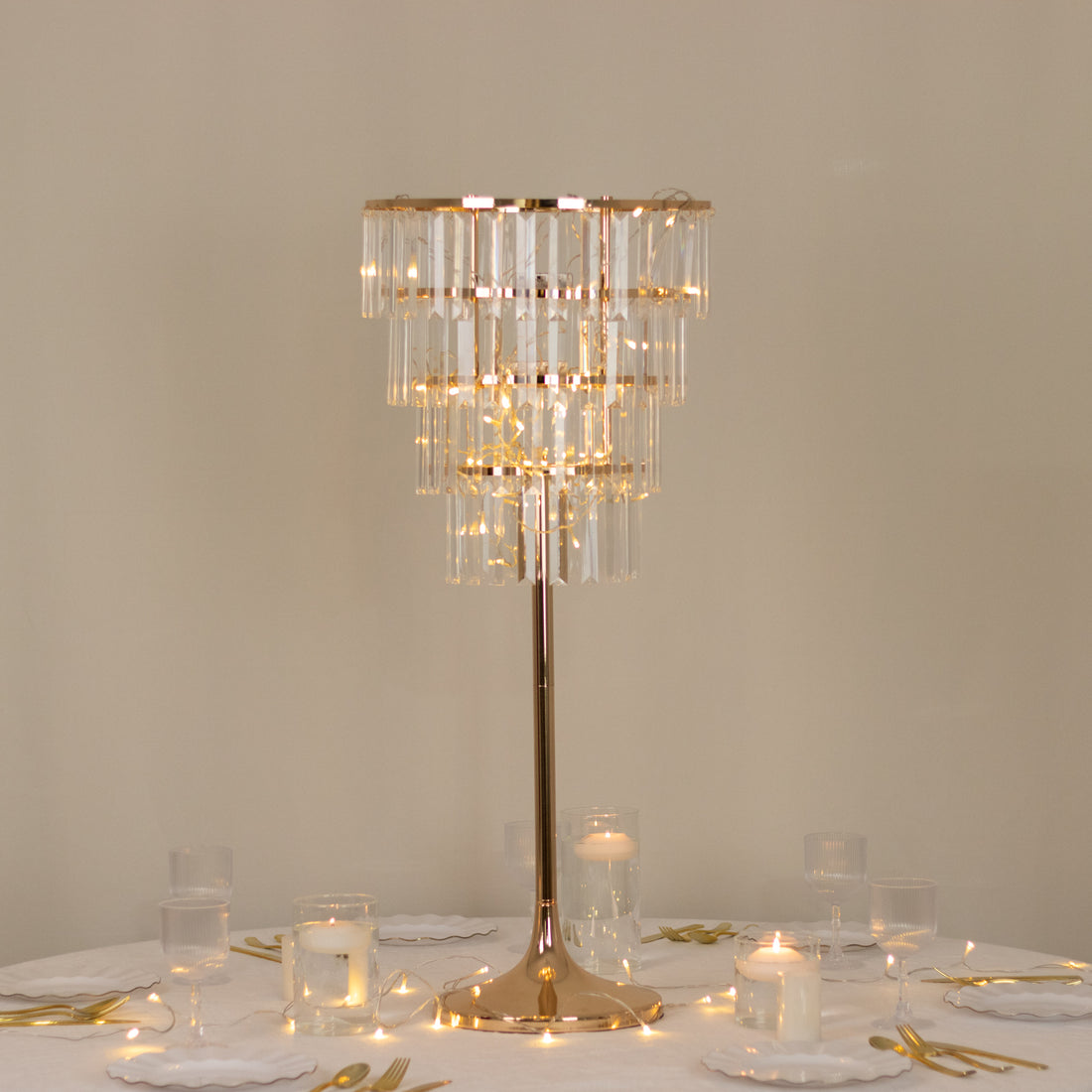 Elegant crystal chandelier table lamp with gold accents.