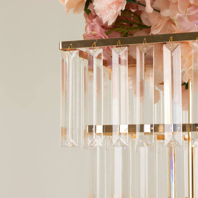 Elegant crystal chandelier with hanging prisms and gold accents.