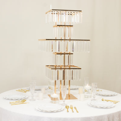 Elegant gold and glass tiered display stand with test tubes on a dining table.