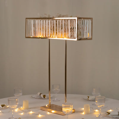 Elegant table lamp with decorative shade and warm lighting on a dining table.