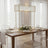 Elegant dining table setting with glassware and floral centerpiece.