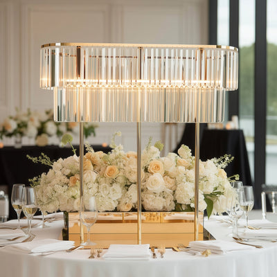 Elegant table lamp with crystal accents and gold base, surrounded by floral arrangement.